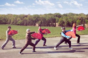 elderly group doing tai chi outdoors with help getting there from Nurse Next Door Aged Home Care Transportation Services