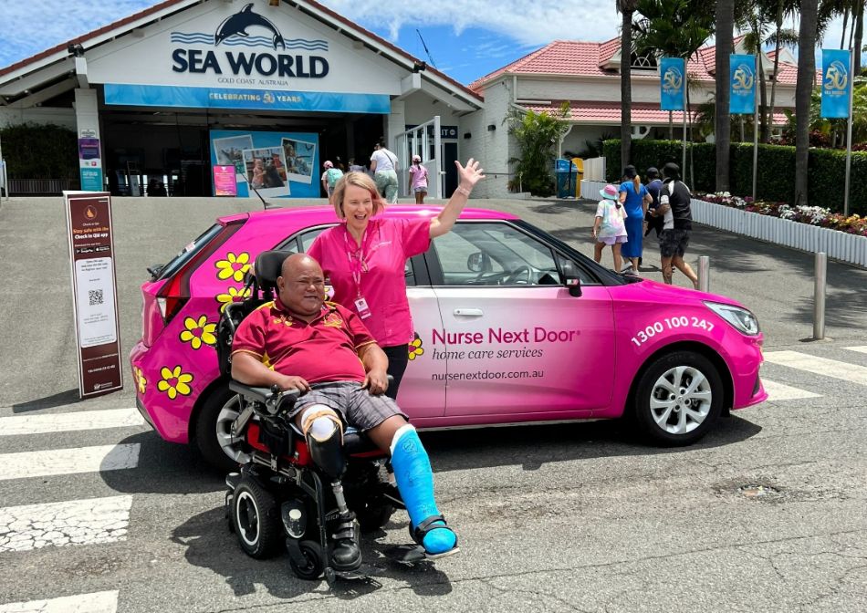 Person in a wheelchair with his carer at Seaworld