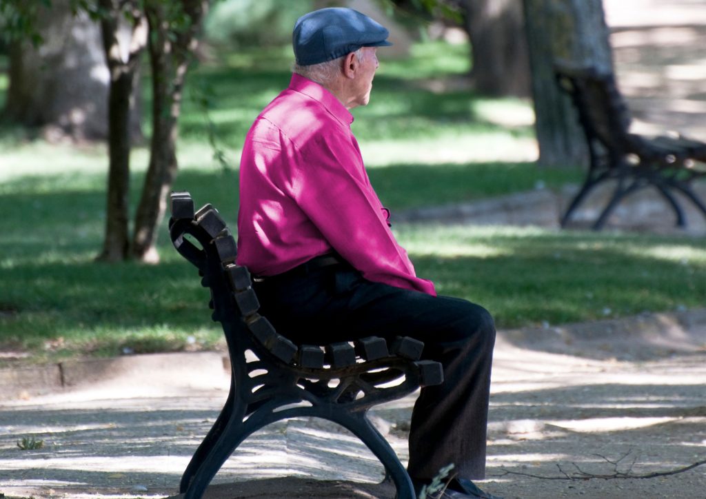 Sad Senior Man sitting alone and park