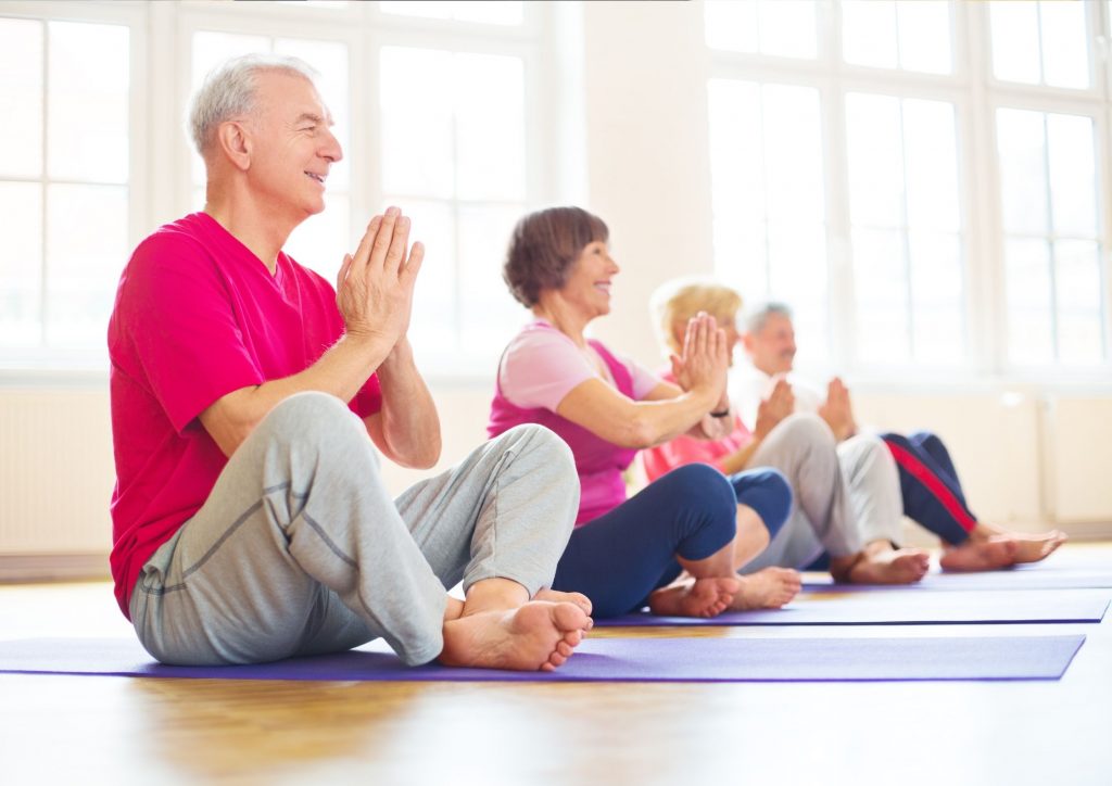 Elderly group enjoying yoga