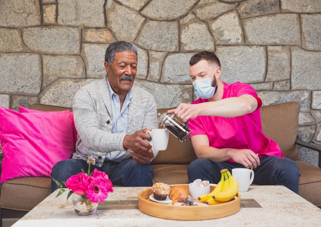 Senior Man having delicious breakfast with hisCaregiver