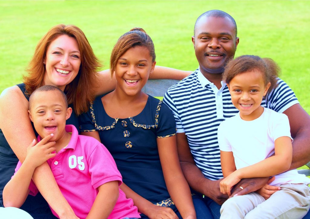 Young boy with Down Syndrome and his family