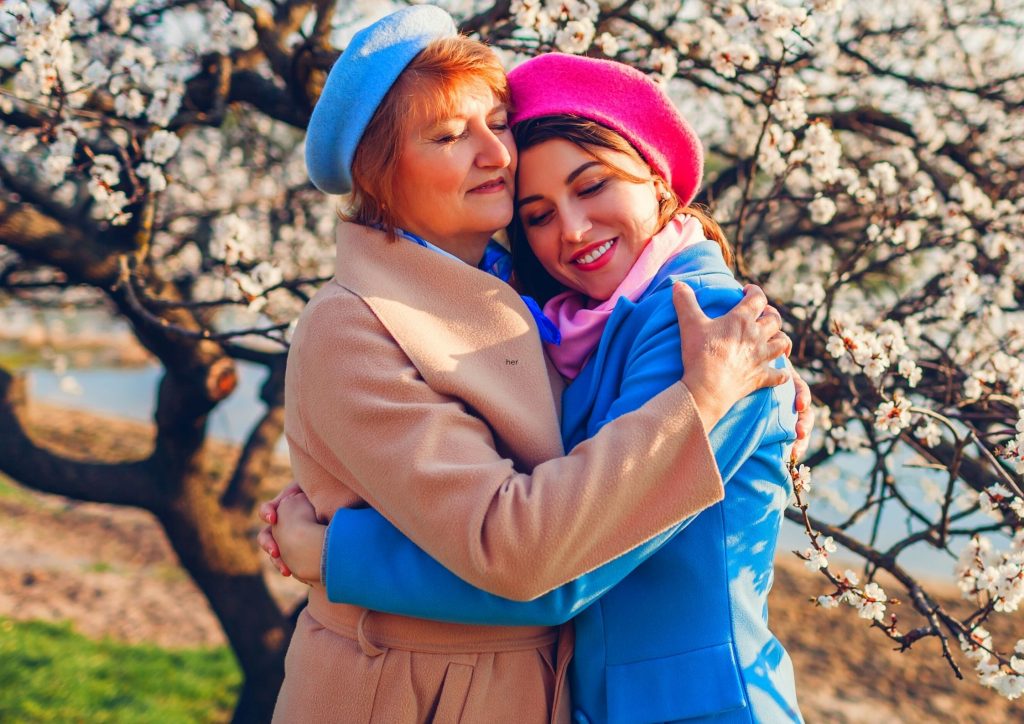 Elderly Mother and Adult Daughter Hugging each other