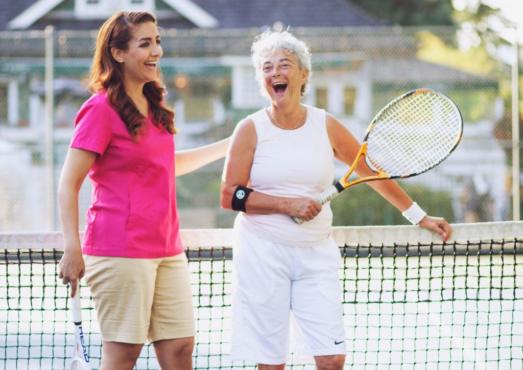 Nurse Next Door Caregiver Playing Tennis with Elderly Client