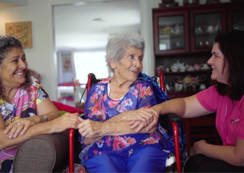 Elderly woman holding hands and showing her appreciation to her caregiver