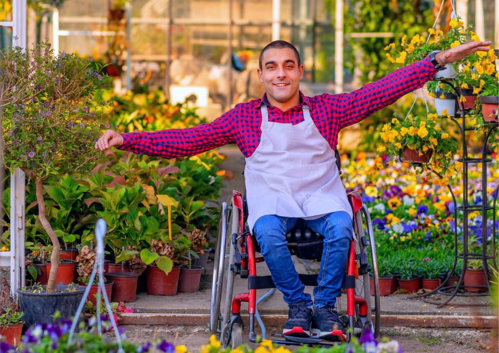 A person with a disability in wheelchair enjoying a garden
