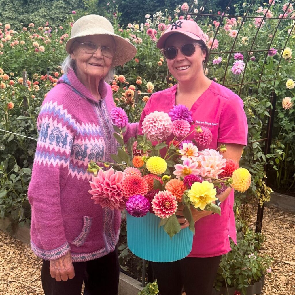 Nurse Next Door Caregiver picking flowers with her elderly client