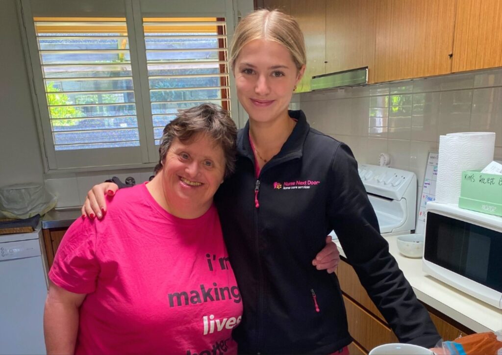 Nurse Next Door Client and Caregiver smiling in the kitchen together
