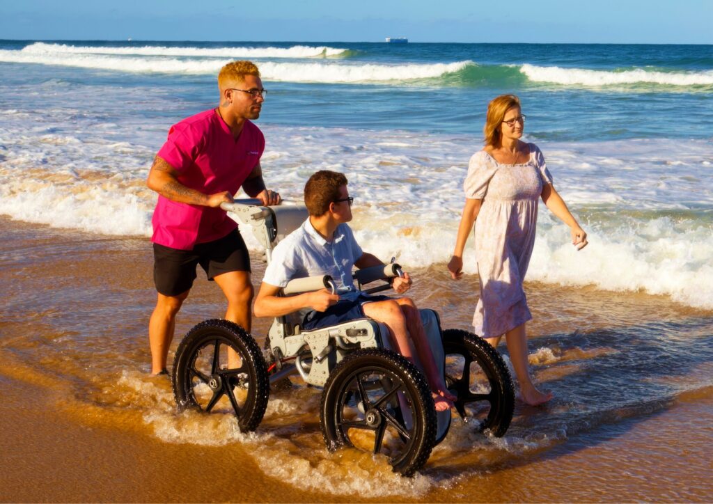 Nurse Next Door client on the beach with his mum and caregiver